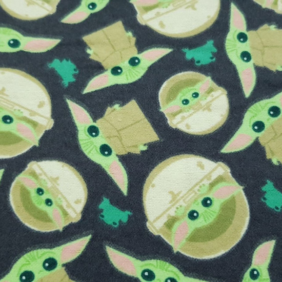 Cotton Flannel Baby Yoda Mandalorian Navy fabric - Cotton flannel fabric licensed with drawings of the character The Child (Baby Yoda) from the Star Wars The Mandalorian series from the Disney + platform, on a dark navy background with green frogs. The fa