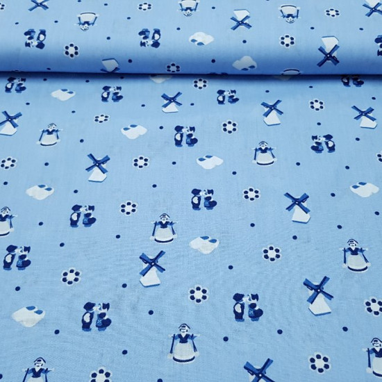 OUTLET Cotton Holland Mills fabric - Cotton fabric with Dutch-themed drawings, in which we find mills, wooden clogs, typical Dutch dress characters, flowers and moles on a blue background.