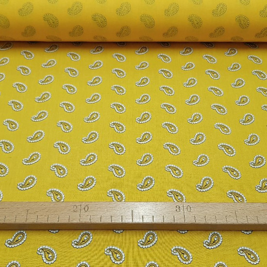 Cotton Yellow Cashmere fabric - Cotton fabric with cashmere style drawings on a yellow background. The fabric is 150cm wide and its composition 100% cotton.
