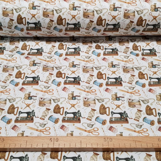 Cotton Vintage Sewing fabric - Satin cotton fabric with vintage drawings on a sewing theme, with sewing machines, scissors, needles, threads, irons... on a white background. The fabric is 140cm wide and its composition is 100% cotton.