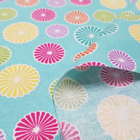 Cotton Tea Party Pin Wheels fabric - Cotton fabric with drawings of swirls or colored umbrellas on a light blue background. The fabric is 110cm wide and its composition is 100% cotton.