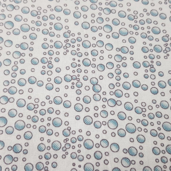 Cotton Sea Bubbles fabric - Cotton fabric with bubble patterns on a white background. The fabric is 110cm wide and its composition is 100% cotton.