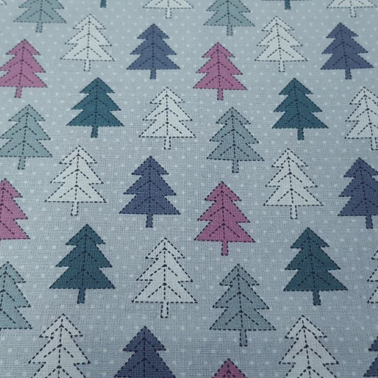 Cotton Christmas Forest Fir Trees fabric - Christmas cotton fabric with drawings of fir trees in straight shapes of various colors on a light background with white dots simulating snow. The fabric is 110cm wide and its composition is 100% cotton.
