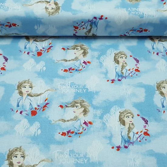 Cotton Disney Frozen 2 Elsa fabric - Disney digital cotton fabric with the character Elsa from the movie Frozen 2 on a light blue background with white trees and clouds. The fabric is 110cm wide and its composition 100% cotton.