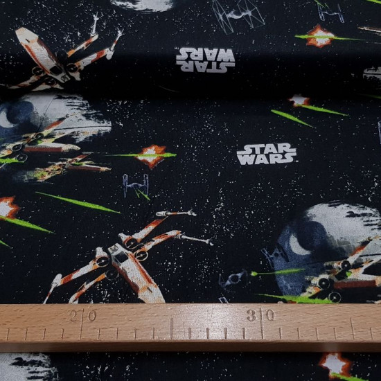 Cotton Star Wars Death Star fabric - Disney licensed cotton fabric with drawings of the Star Wars death star and other ships on a black space background with Star Wars logos. The fabric is 110cm wide and its composition is 100% cotton.