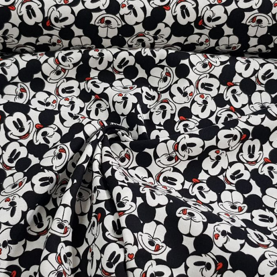 Cotton Disney Mickey Faces Allover White fabric - Disney licensed cotton fabric with drawings of Mickey's faces close together and in various positions on a white background. The fabric is 110cm wide and its composition is 100% cotton.