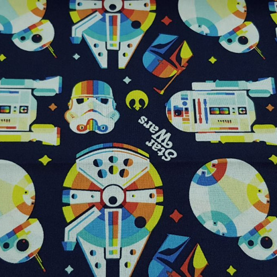 Cotton Star Wars Rainbow fabric - Cotton licensed fabric with Star Wars drawings in a “rainbow” style where the Millennium Falcon, R2-D2, BB-8, the Mandalorian helmets and the imperial army appear… on a navy blue background. The fabric is 110cm wide
