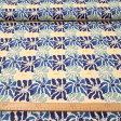 Cream cotton poplin fabric with a graphic pattern of large flowers in blue, mint green, and footprints with the silhouette of Simba from The Lion King.