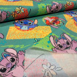 Teal cotton poplin fabric with a Stitch and Angel print on yellow and green geometric shapes in a 90s style