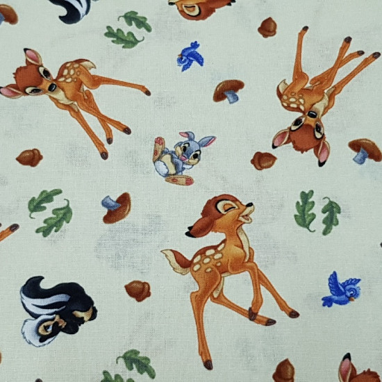 Tela Algodón Disney Bambi - Preciosa tela Disney de algodón con los dibujos de Bambi, Tambor y Flor sobre un fondo amarillo claro. También hay adornos de setas, ramas de árbol y pajaritos. La tela mide 110cm de ancho y su composición 100% algod
