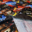 Cotton Disney Cars Mosaic fabric - Children's cotton fabric with drawings of Disney Cars cars, on a background where Lightning McQueen, Mate, Rey appear ... The fabric is 140cm wide and its composition is 100% cotton.