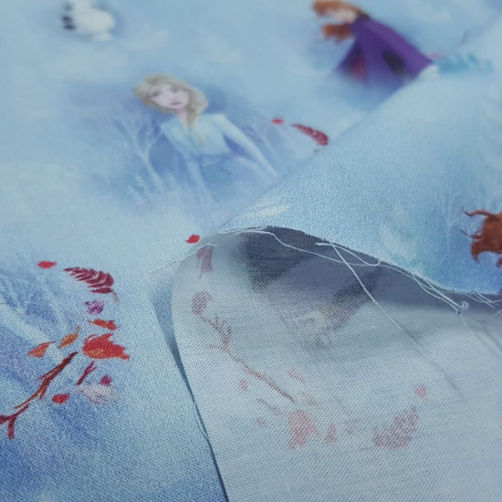 Cotton Disney Frozen 2 Blue fabric - Disney licensed cotton poplin fabric with drawings of the characters Elsa, Anna and Olaff from the movie Frozen 2 on a blue background with the snowy forest. The fabric is 140cm wide and its composition is 100% cotto