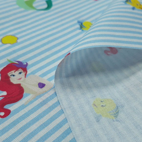 Cotton Disney the Little Mermaid Stripes fabric - Disney licensed cotton fabric with drawings of Ariel, the little mermaid, along with the characters Sebastian the crab and Flounder the fish, on a background of blue stripes. The fabric is 150cm wide and i