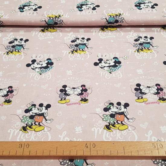 Cotton Disney Love Mickey Minnie fabric - Disney licensed cotton fabric with drawings of the characters Mickey and Minnie in love with background letters with the word love in various languages ​​and shapes of hearts. The fabric is 150cm wide and its comp