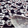 Cotton Disney Mickey Faces Allover Pink fabric - Disney licensed cotton fabric with drawings of Mickey's faces together and in various positions on a light pink background. The fabric is 110cm wide and its composition is 100% cotton.
