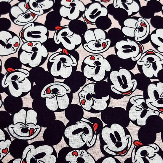 Cotton Disney Mickey Faces Allover Pink fabric - Disney licensed cotton fabric with drawings of Mickey's faces together and in various positions on a light pink background. The fabric is 110cm wide and its composition is 100% cotton.