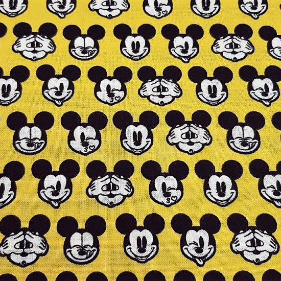 Cotton Disney Mickey Faces Yellow fabric - Disney licensed cotton fabric with drawings of Mickey faces making faces on a yellow background. The fabric is 110cm wide and its composition is 100% cotton.
