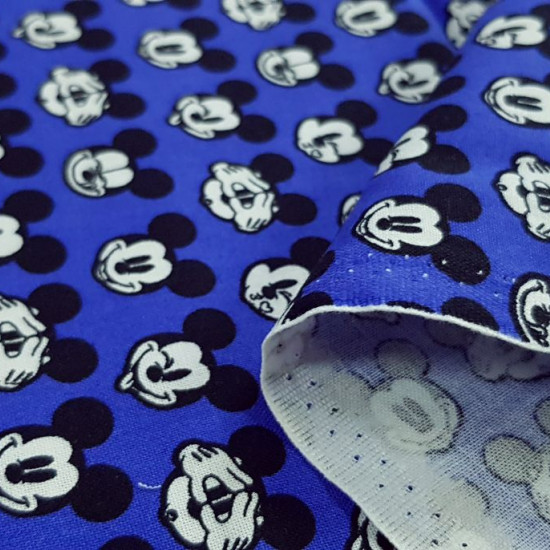Cotton Disney Mickey Faces Blue fabric - Disney licensed cotton fabric with drawings of Mickey faces making faces on a blue background. The fabric is 110cm wide and its composition is 100% cotton.