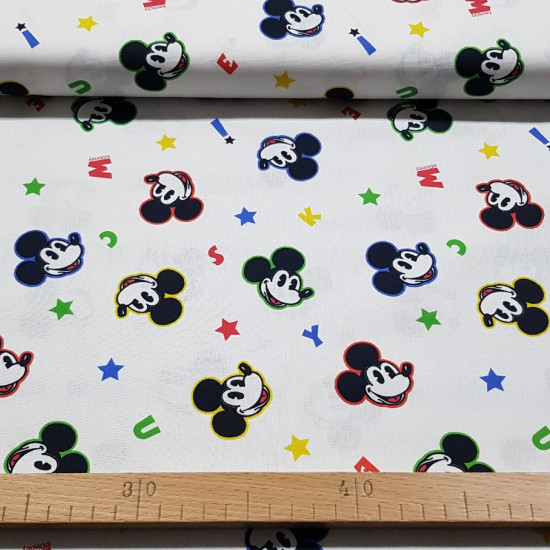 Cotton Disney Mickey Faces Letters fabric - Disney licensed cotton fabric with drawings of faces with the colored outline of the Mickey character on a white background with colored letters. The fabric is 150cm wide and its composition is 100% cotton.