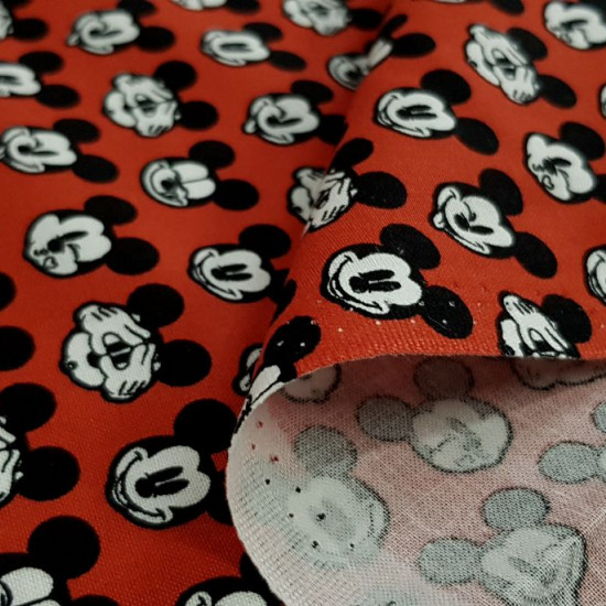 Cotton Disney Mickey Faces Red fabric - Disney licensed cotton fabric with drawings of Mickey faces making faces on a red background. The fabric is 110cm wide and its composition is 100% cotton.