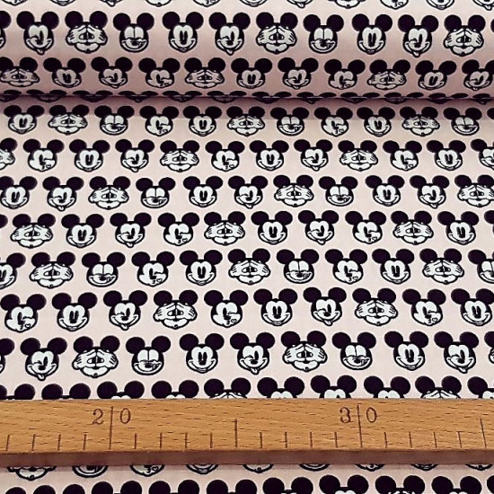 Cotton Disney Mickey Faces Pink fabric - Disney licensed cotton fabric with drawings of Mickey's faces making faces on a light pink background. The fabric is 110cm wide and its composition is 100% cotton.