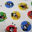 Cotton Disney Mickey Classic Circles fabric - Licensed Disney cotton fabric with drawings of the classic Mickey character in bold colorful circles on a white background. The fabric is 150cm wide and its composition is 100% cotton.