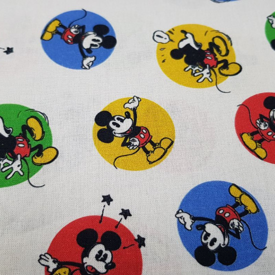 Cotton Disney Mickey Classic Circles fabric - Licensed Disney cotton fabric with drawings of the classic Mickey character in bold colorful circles on a white background. The fabric is 150cm wide and its composition is 100% cotton.