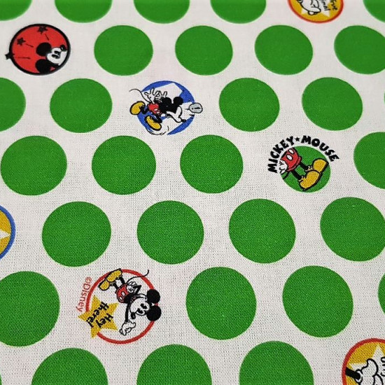 Tela Algodón Disney Mickey Lunares Verdes - Tela de algodón licencia con dibujos de Mickey Mouse dentro de círculos o lunares con fondo blanco y lunares verdes alrededor. La tela mide 150cm de ancho y su composición 100% algodó