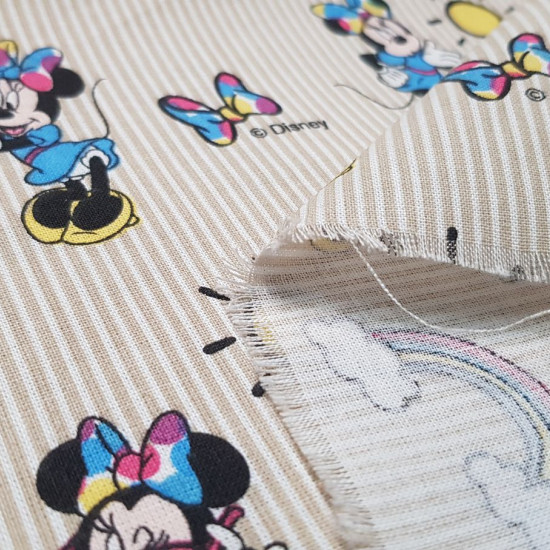 Cotton Disney Minnie Rainbow fabric - Disney children's cotton fabric with drawings of the character Minnie, rainbows, suns and bows, on a background of beige stripes. The fabric is 140cm wide and its composition 100% cotton.