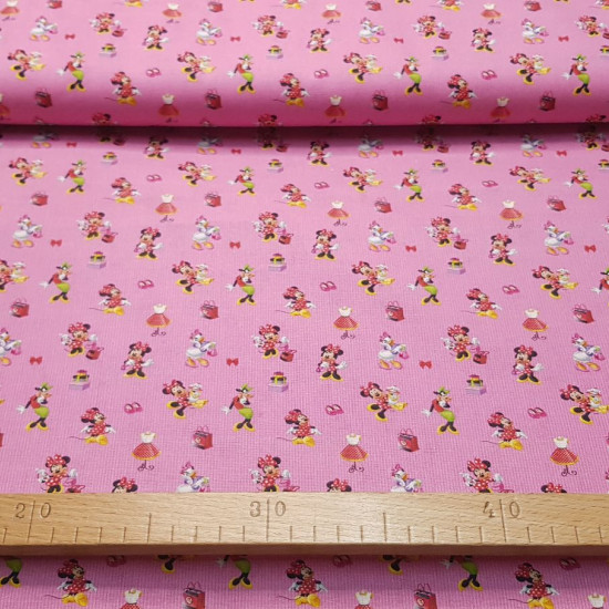 Cotton Disney Minnie Daisy Boutique fabric - Disney licensed cotton fabric with small drawings of Minnie, Daisy and Clarabella characters on a pink/fuchsia striped background and fashion boutique items. The fabric is 140cm wide and its composition is 100%