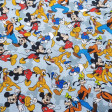 Cotton Disney Characters Collage Blue fabric - Licensed cotton poplin fabric with drawings of Disney characters such as Mickey Mouse, Goofy, Donald, Pluto... forming a collage on a light blue background. The fabric is 140cm wide and its composition is 100