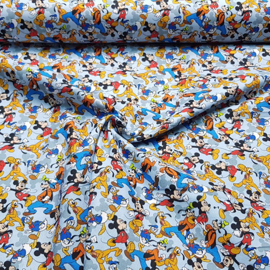 Cotton Disney Characters Collage Blue fabric - Licensed cotton poplin fabric with drawings of Disney characters such as Mickey Mouse, Goofy, Donald, Pluto... forming a collage on a light blue background. The fabric is 140cm wide and its composition is 100