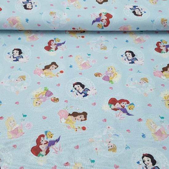 Cotton Disney Princesses Blue fabric - Disney cotton fabric with the drawings of princesses like Ariel, Rapuntzel, Bella, Snow White, Cinderella and Aurora on a light blue background with hearts.