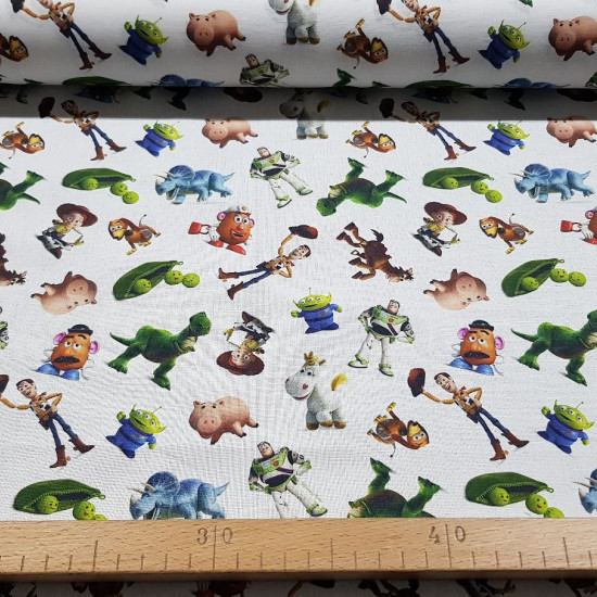 Cotton Disney Toy Story Characters fabric - Disney licensed cotton fabric with drawings of the characters from the movie Toy Story on a white background. The fabric measures between 140-150cm wide and its composition is 100% cotton.