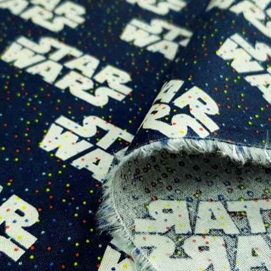 Cotton Star Wars Rainbow Logos fabric - Cotton fabric licensed Star Wars where logos appear on a navy blue background with tiny multicolored polka dots. The fabric is 110cm wide and its composition is 100% cotton.