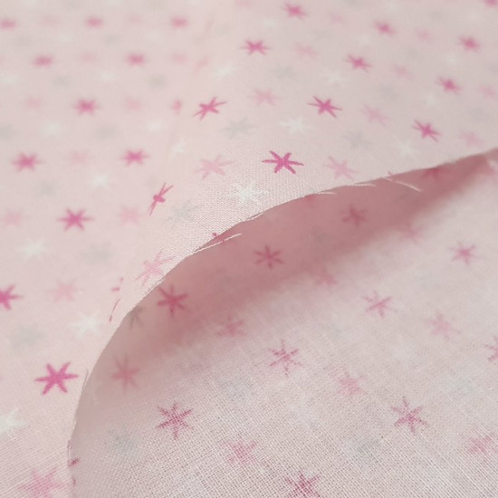 Cotton Stars Pink Tones fabric - Cotton fabric with drawings of stars in pink, fuchsia, gray and white tones on a light pink background. The fabric is 150cm wide and its composition 100% cotton