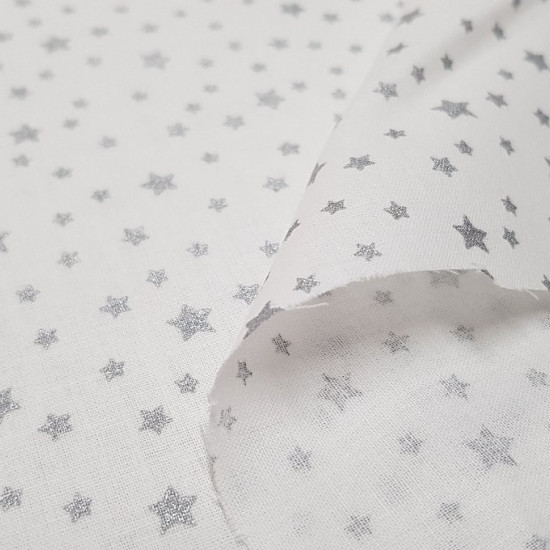 Cotton Shining Stars Silver fabric - Cotton fabric with drawings of bright silver stars on a white background. This fabric is perfect for Christmas-themed decorations, for example. The fabric is 150cm wide and its composition 100% cotton.