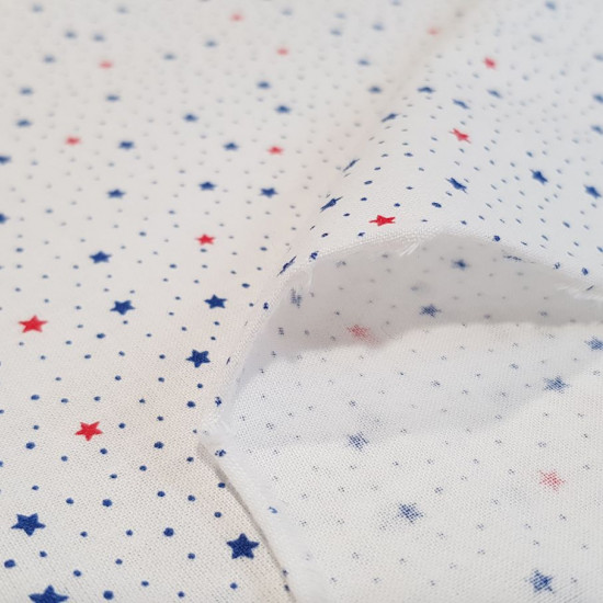 Cotton Multicolor Stars fabric - Fine cotton fabric with patterns of blue and red stars on a white background with little blue dots. The fabric is 150cm wide and its composition is 100% cotton.