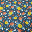 Cotton Flowers Flua Blue fabric - Organic cotton fabric with drawings of various colored flowers on a blue background. The fabric is 150cm wide and its composition is 100% cotton.
