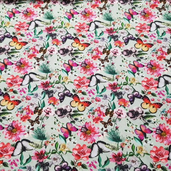 Algodón Flores Mariposas - Tela de algodón tipo popelín con dibujos florales combinado con mariposas de colores sobre un fondo de color verde. La tela mide 150cm de ancho y su composición 100% algodón.