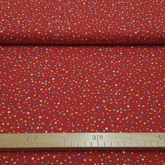 Cotton Multicolor Polka Dots Red Background fabric - Poplin cotton fabric with drawings of multicolored polka dots of different sizes on a red background. The fabric is 150cm wide and its composition is 100% cotton.