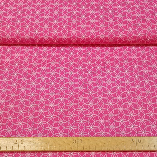 Cotton Floral Shapes Fuchsia fabric - Organic cotton fabric with white floral geometric patterns on a fuchsia background. The fabric is 150cm wide and its composition is 100% cotton.