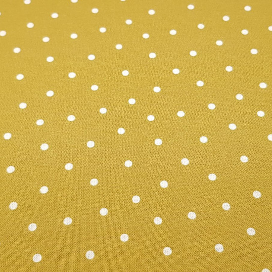 Cotton Dots Lys fabric - Organic cotton poplin fabric with drawings of white dots on a colored background. The fabric is 150cm wide and its composition is 100% cotton.