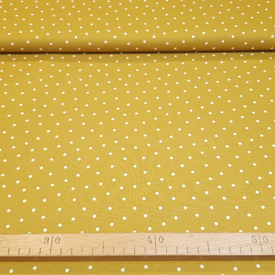 Cotton Dots Lys fabric - Organic cotton poplin fabric with drawings of white dots on a colored background. The fabric is 150cm wide and its composition is 100% cotton.