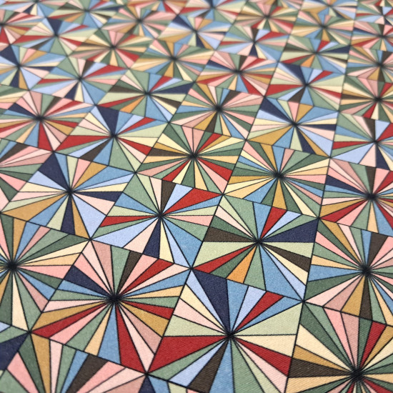 Cotton Mosaic Ornamental Geometric fabric - Cotton poplin fabric with geometric patterns forming an ornamental mosaic of multicolored triangles. The fabric is 150 cm wide and is made of 100% cotton.