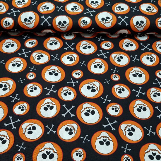 Cotton Skulls Circles fabric - Cotton fabric with skulls in orange circles on a black background.