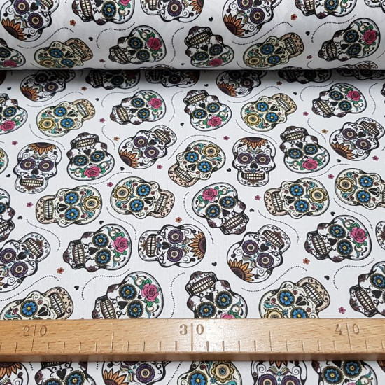 Cotton Mexican Skull Calacas White fabric - Printed cotton fabric with drawings of calacas or skulls typical of the Day of the Dead in a variety of colors and a flowered white background. The fabric is 140cm wide and its composition 100% cotton.