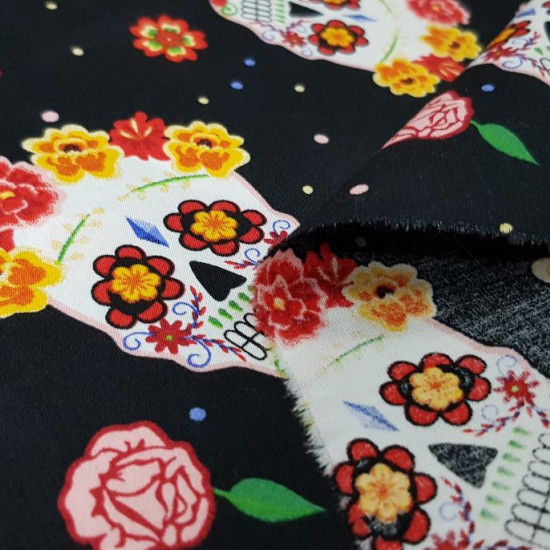 Cotton Skulls Colors Black fabric - Pretty cotton fabric with a Halloween theme, with drawings of colorful Mexican skulls with colorful flowers on a black background. They are very showy and colorful skulls! The fabric is 140cm wide and its composition