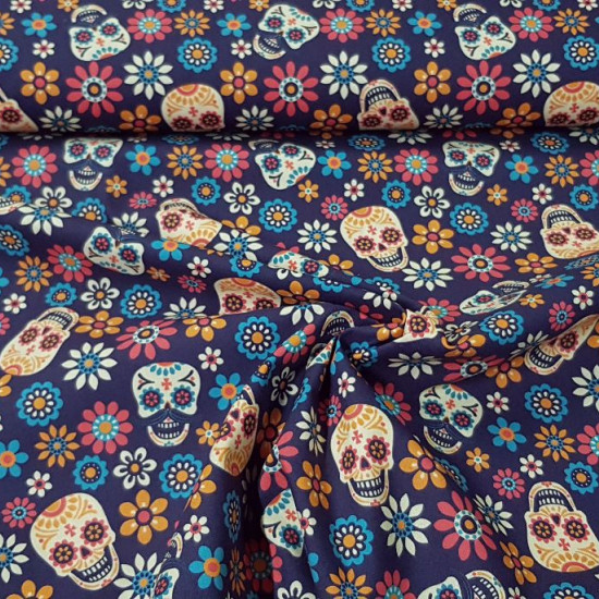 Cotton Floral Skulls Violet fabric - Digitally printed cotton fabric with colorful floral skull drawings on a dark purple background. The fabric is 140cm wide and its composition 100% cotton