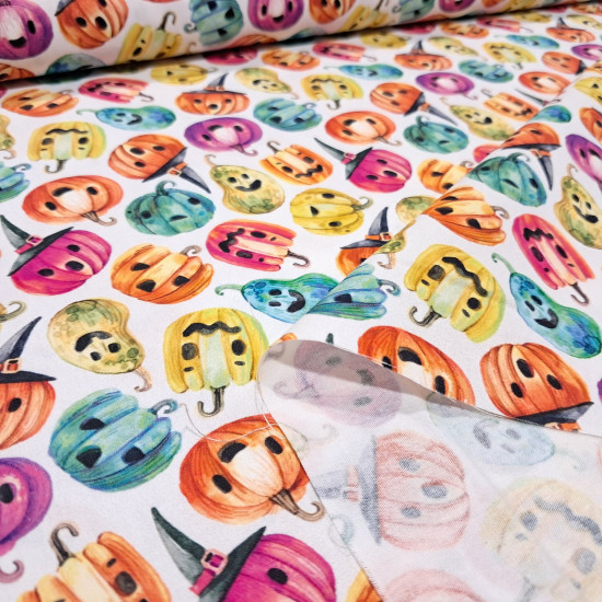 Cotton Halloween Pumpkins Colors Spooky fabric - Cotton poplin fabric with Halloween-themed designs featuring colorful pumpkins with faces and decorated hats on a white background. The fabric is 150 cm wide and is made of 100% cotton.